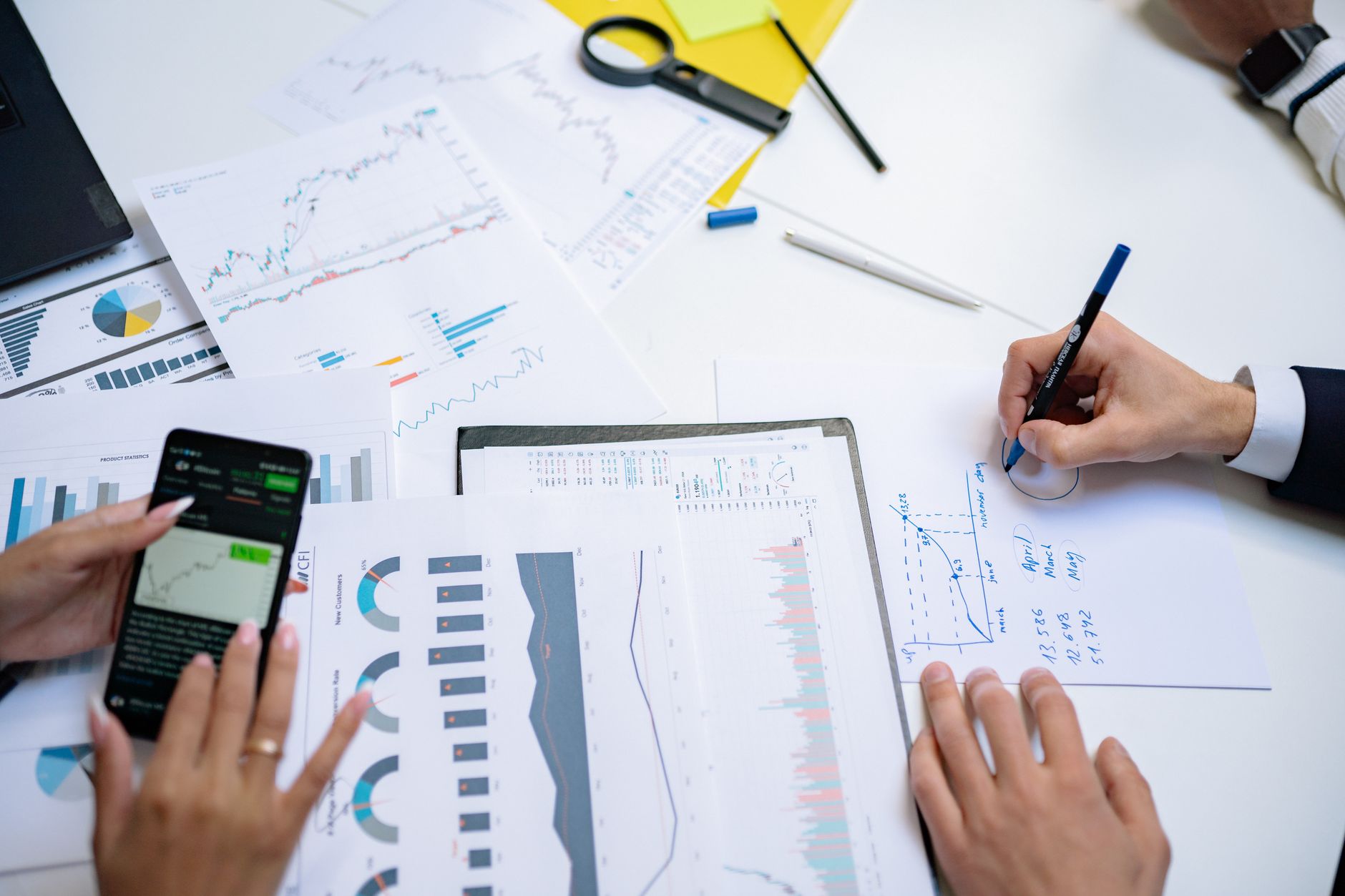 Business team analyzing financial charts for seasonal trends.