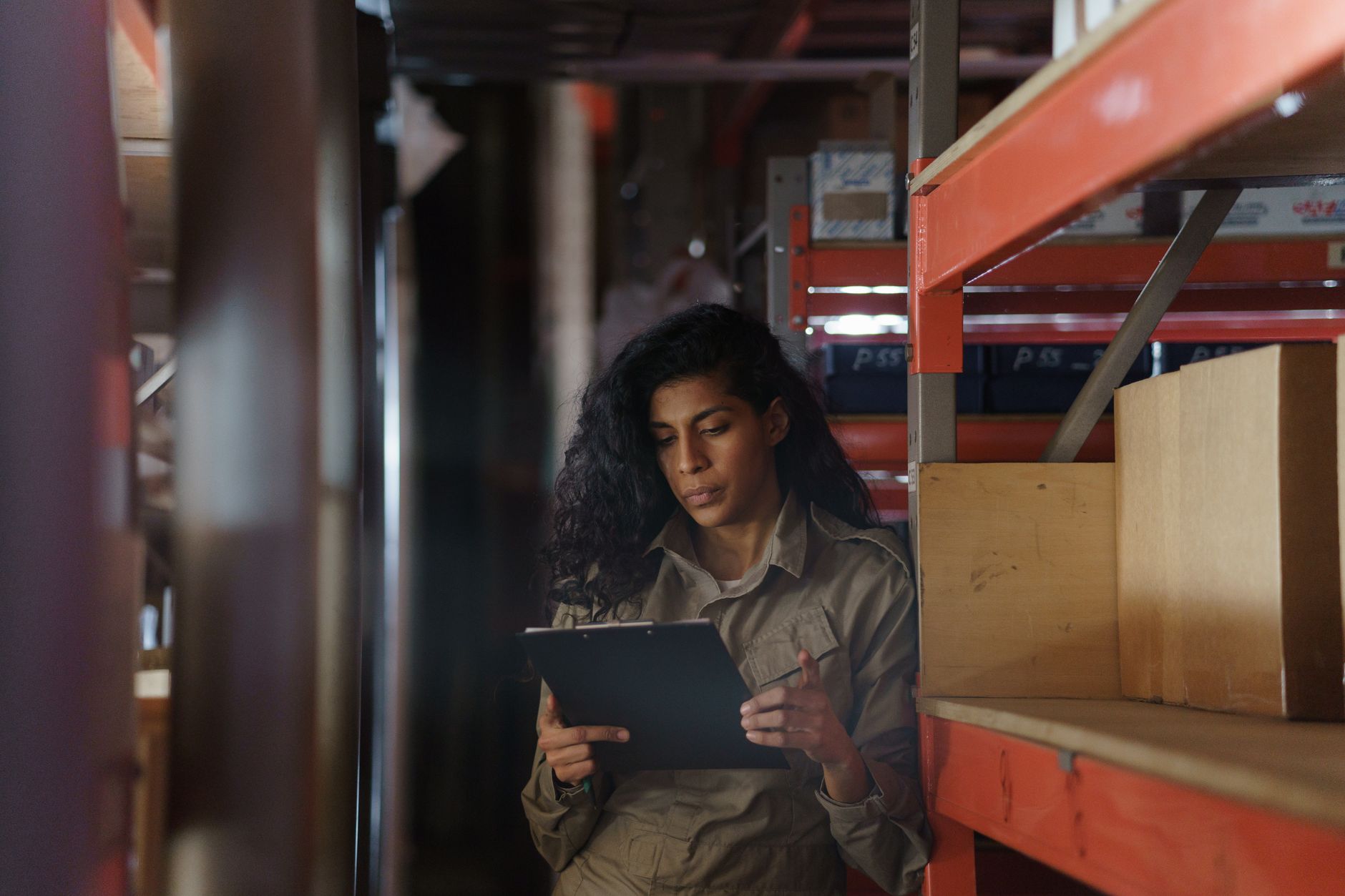 Manager checking inventory in a warehouse, highlighting cash flow impact.