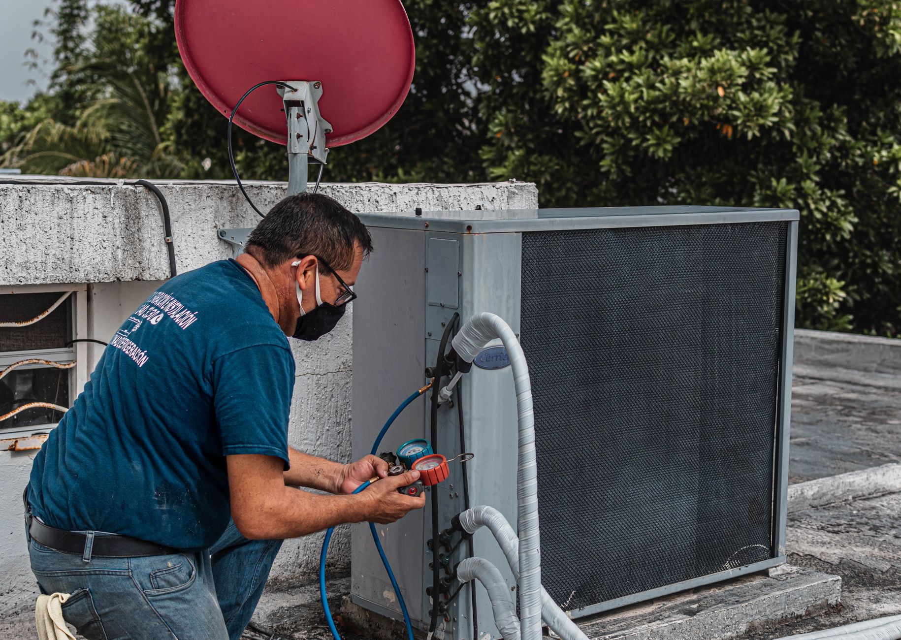 Technician working on an HVAC system, showcasing job complexity.