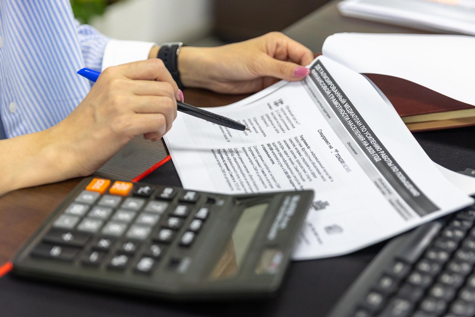 An accountant entering data into multiple systems, illustrating duplicate data entry issues.
