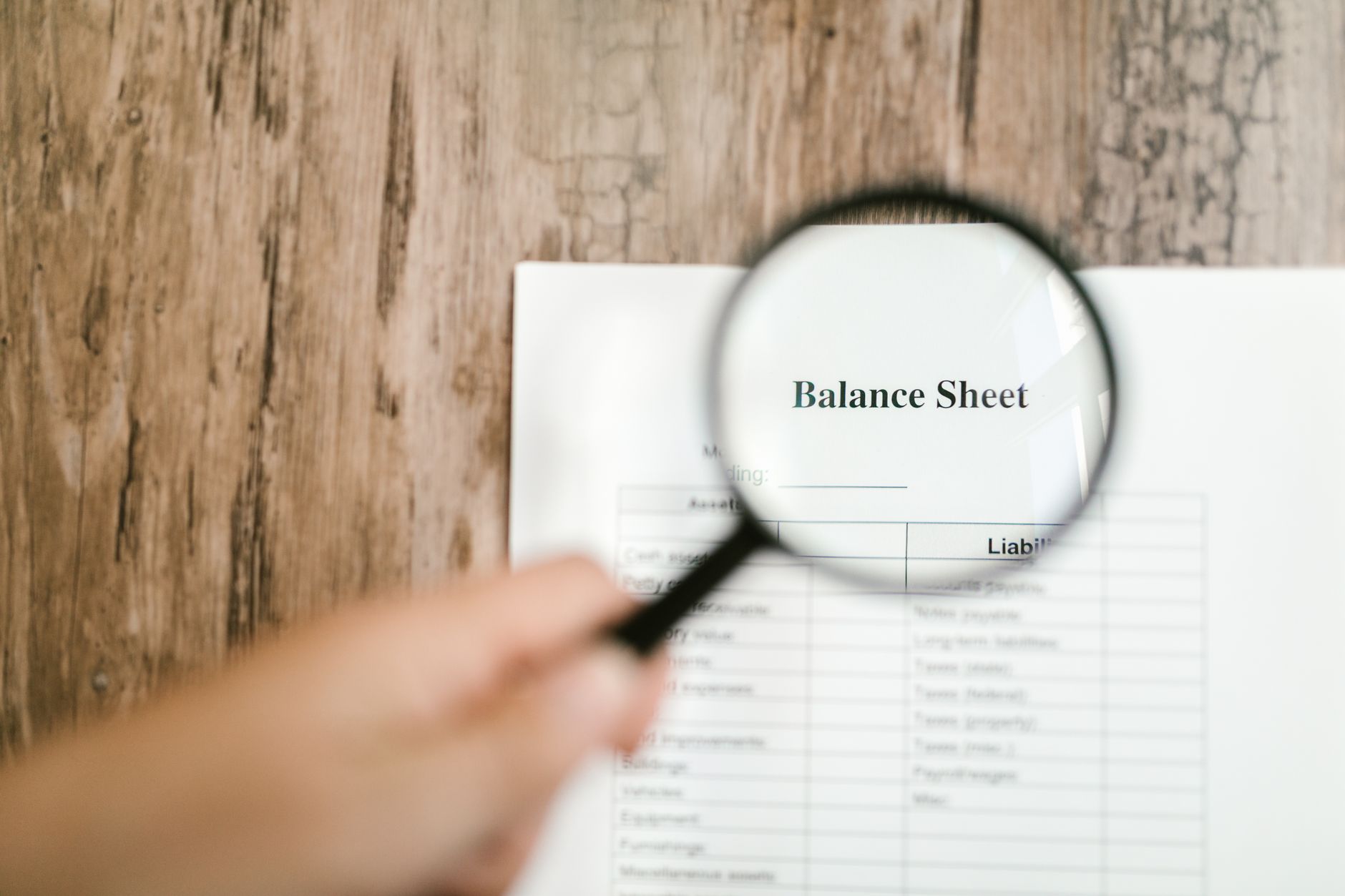 Profit and Loss Statement and Balance Sheet on a desk with a calculator.